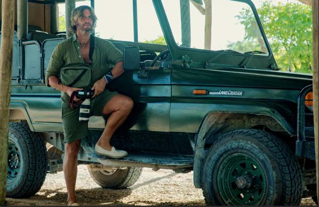 Sky with his camera in a safari vehicle