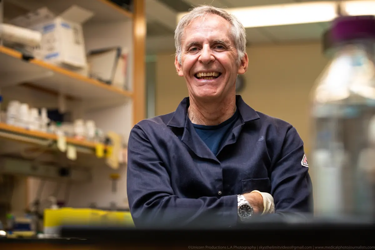 Professor of Biological Sciences and Biomedical Engineering at a laboratory bench